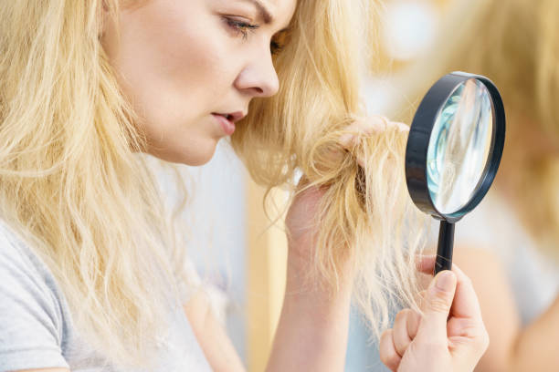 istock Woman looking at her through magnifer 1203999762