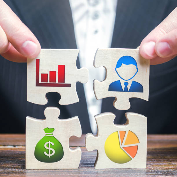 istock A businessman collects puzzles symbolizing individual elements and attributes of doing business. Project management. Good planning, Organization of the process, the creation of a business model. 1204000317
