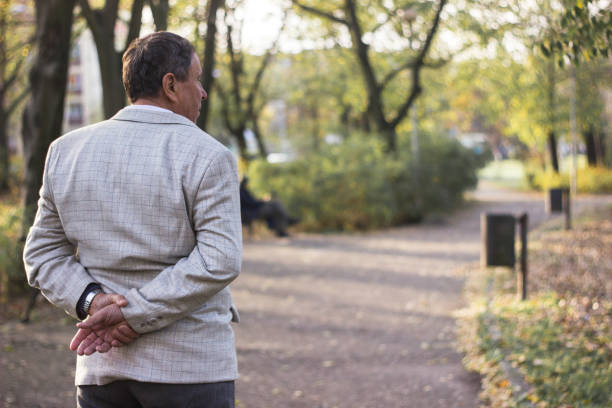 istock Senior man walking and relaxing in park 1204000371