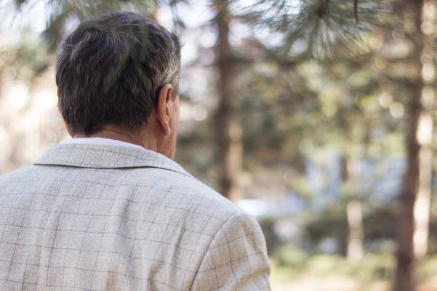 istock Senior man walking and relaxing in park 1204000721