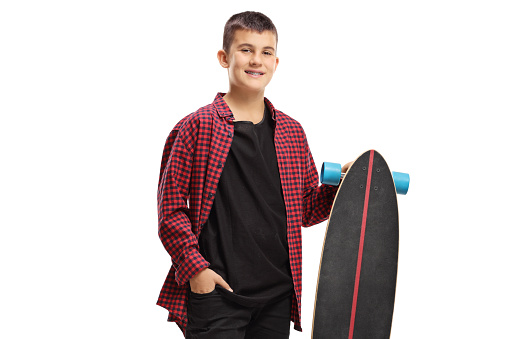 Smiling kid holding a longboard isolated on white background