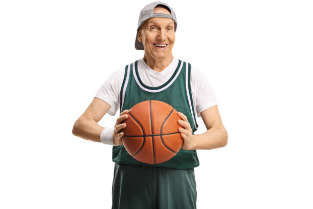 старший человек в джерси проведения баскетбол и улыбается - basketball basketball player shoe sports clothing стоковые фото и изображения