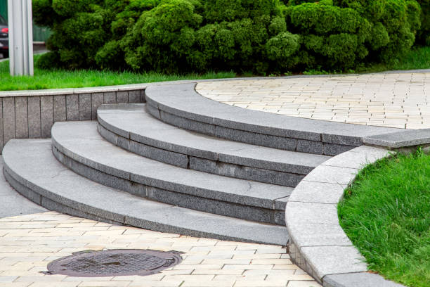 istock a staircase with granite stone steps in the park with a rectangular pavement and green lawns with bushes, close up. 1204003662