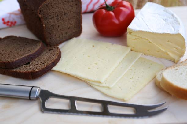 istock White and black bread, different varieties of cheese and knife view from above 1204003663