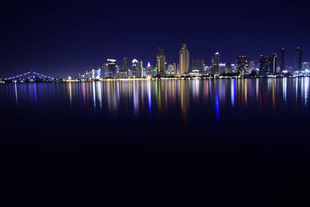 beautifully illuminated san diego urban skyline from san diego bay against clear night sky - san diego california san diego bay fun bay imagens e fotografias de stock