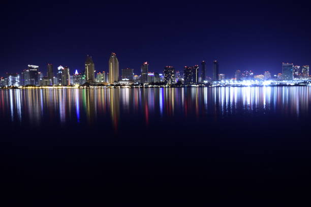 beautifully illuminated san diego urban skyline from san diego bay against clear night sky - san diego california san diego bay fun bay imagens e fotografias de stock