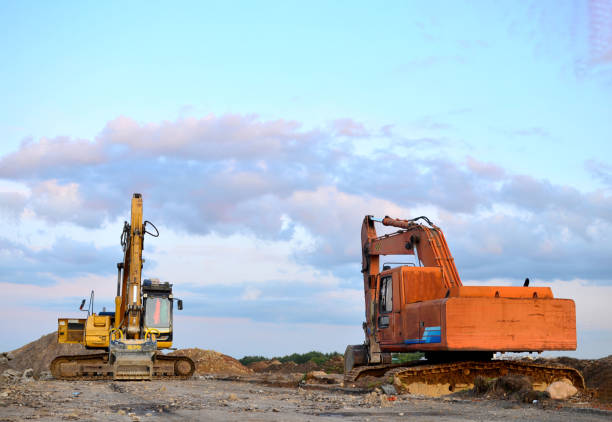 istock Two excavators at a construction site. Excavator with crusher bucket for crushing concrete 1204005508