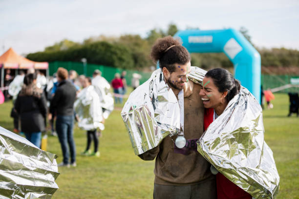 istock Happy couple sharing foil blanket after Stampede race 1204006717