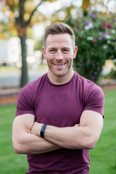 istock Muscular man with arms crossed, smiling at camera 1204007153