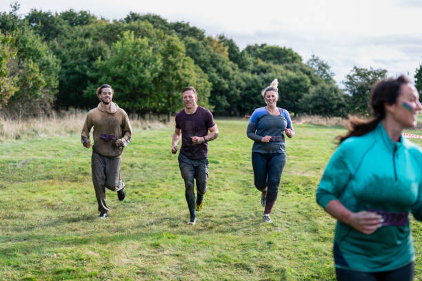 istock Charity event competitors running across field 1204007829