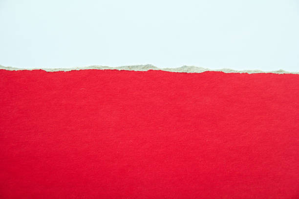 istock Red torn piece of cardboard paper with rough surface on white background. Copy space for text message. 1204008097