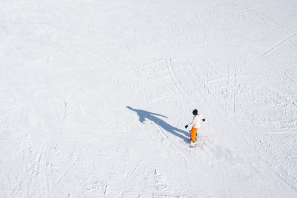 istock High angle view of unrecognizable person snowboarding 1204009686