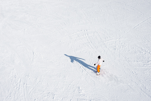 High angle view of unrecognizable person snowboarding