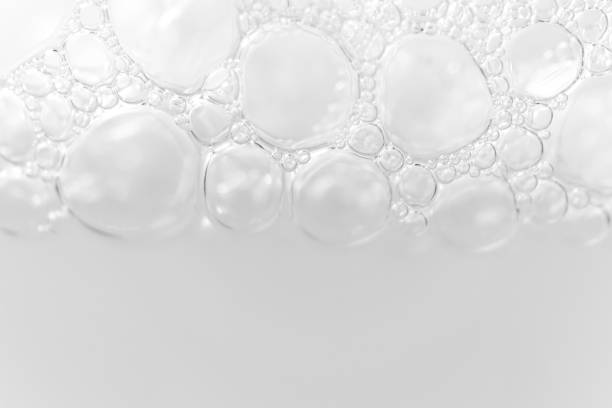 istock Border from foam bubbles from soap, shampoo or cleanser on white background with selective focus and copy space. Macro 1204010649