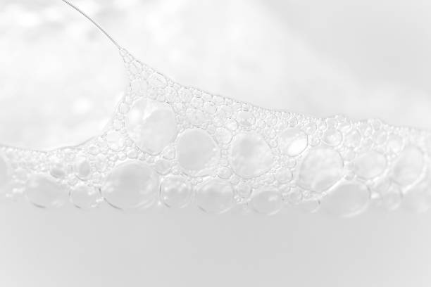 istock Close-up foam bubbles texture from soap, shampoo or cleanser on white background with selective focus and copy space. Macro 1204010733
