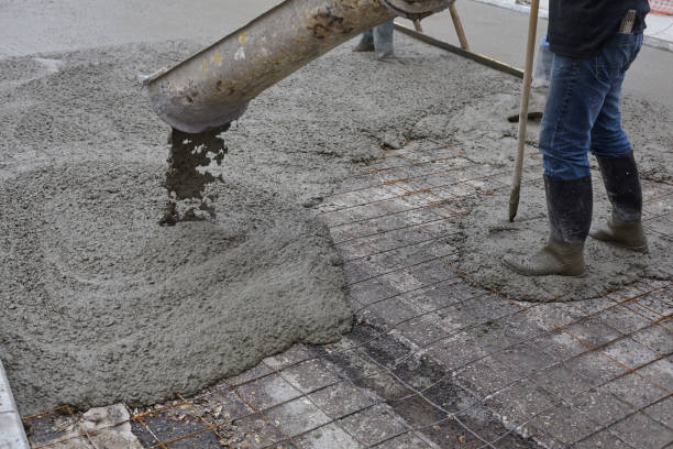 istock workers pouring wet concrete using concrete bucket. Industrial construction. 1204011180