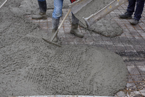 istock workers pouring wet concrete using concrete bucket. Industrial construction. 1204011318