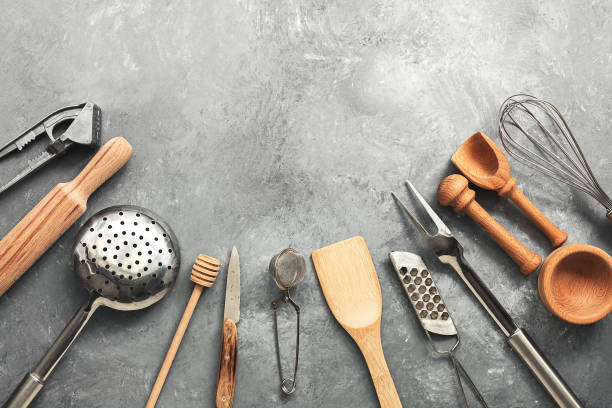 istock A variety of kitchen utensils and tools on a gray concrete rustic background. Top view, flat lay, copy space. 1204013179
