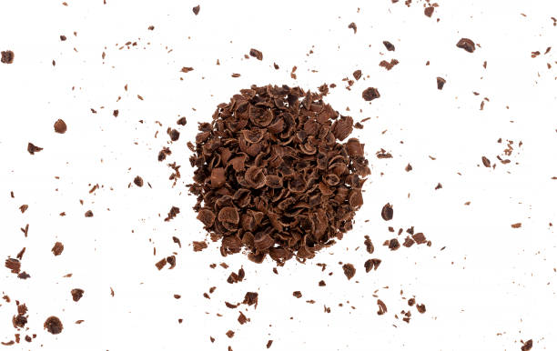 istock Grated chocolate pieces isolated on white background, closeup 1204014000