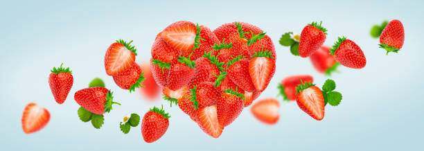 istock Heart made of strawberries isolated on white background 1204014151
