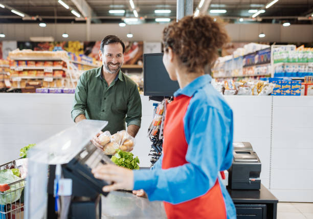 istock Serving customers in modern Latin American supermarket 1204017803