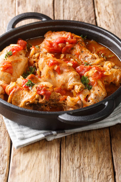istock Braised rabbit in tomato sauce with white wine and herbs close-up in a pan. vertical 1204017891
