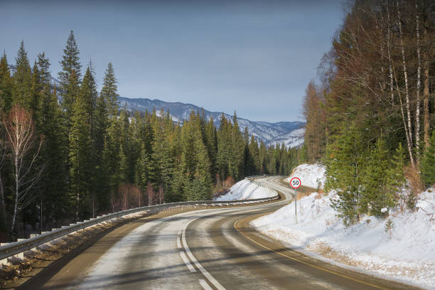 istock Winter road on mountains. Sunny weather. 1204018129