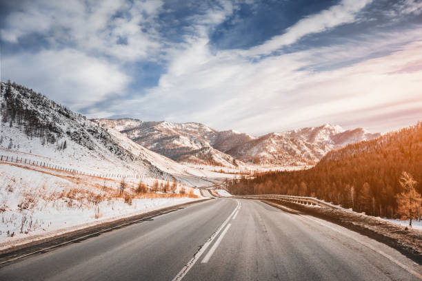 istock Winter road on mountains. Sunny weather. 1204018131