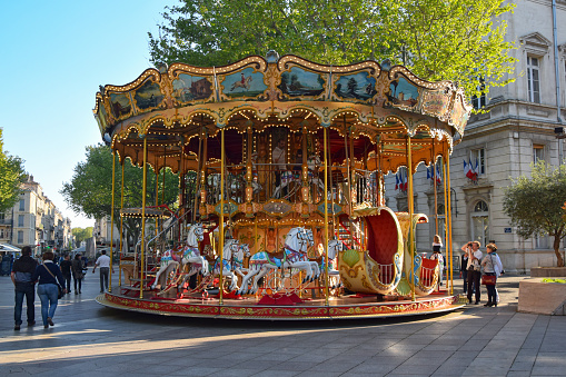Avignon, France - 20 April, 2015: Classic carousel on a street with unidentified people. First French carousel was in Paris in 1605.
