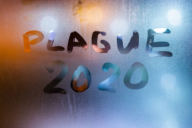 istock the words plague 2020 handwritten on sweat window glass surface at night 1204019008