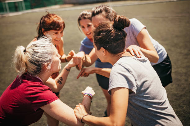 istock Female soccer team huddling and shouting 1204020481
