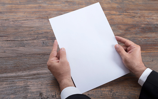 Person holding white empty paper