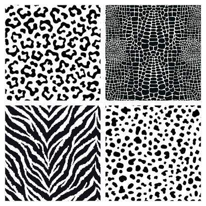 Set of 4 black and white animal fur, skin seamless patterns. Exotic backgrounds. Vector wallpapers.