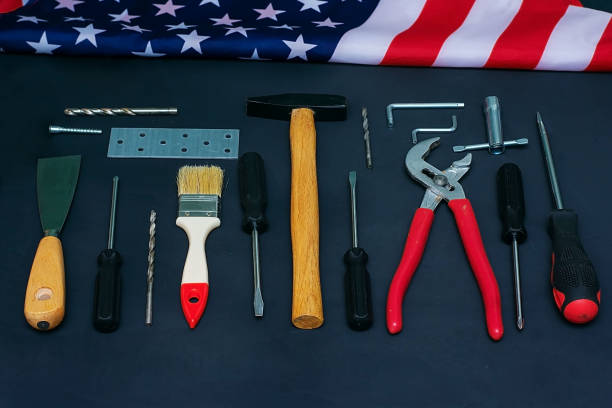istock USA Labor Day. Different tools and american flag on a black background 1204024205