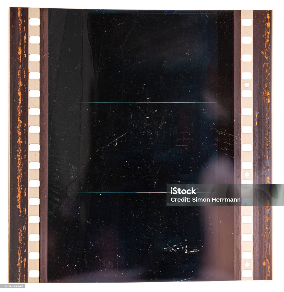 real macro photo of original 70mm film material or strip on white background with empty exposed frames or cells large format 70mm film material on white, cinefilm detail Camera Film Stock Photo