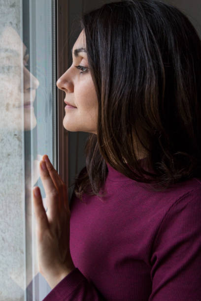 istock young woman Thoughtful by the window 1204025670