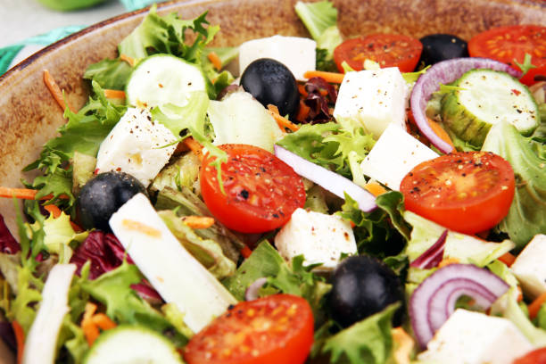 istock Authentic fresh salad in a stone cup with dumbbells excercise equipment, measuring tape on table. healthy lifestyles, good health Concept with fresh ingredients 1204026616