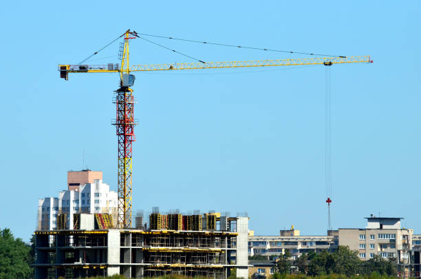 istock Tower cranes constructing a new residential building at a construction site 1204026902