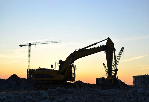 istock Excavator with crusher bucket for crushing concrete at a construction site on a background sunset 1204027968