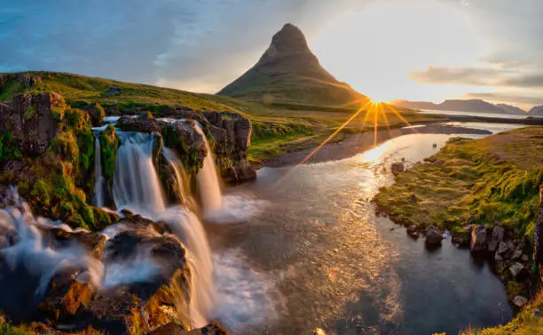 Beautiful landscape with sunrise on Kirkjufellsfoss waterfall and Kirkjufell mountain, Iceland, Europe.