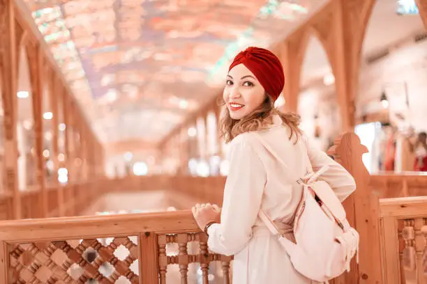 Photo of Tourist woman wearing turban scarf shopping in vintage Dubai market