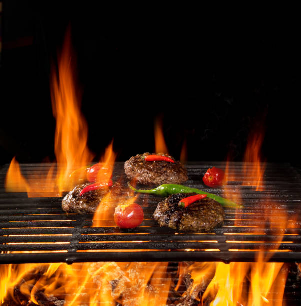 istock Tasty beef steaks flying above cast iron grate with fire flames. 1204033222