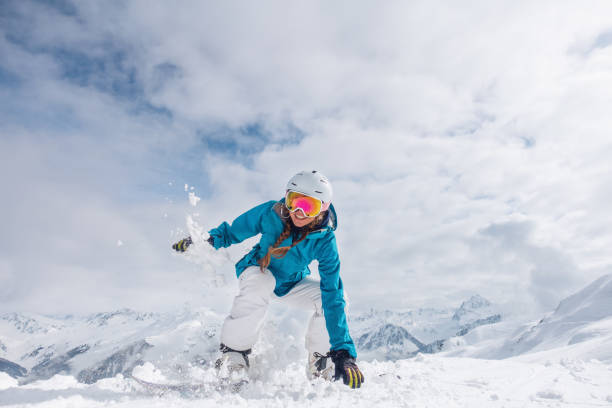 istock Happy female snowboarder 1204033463