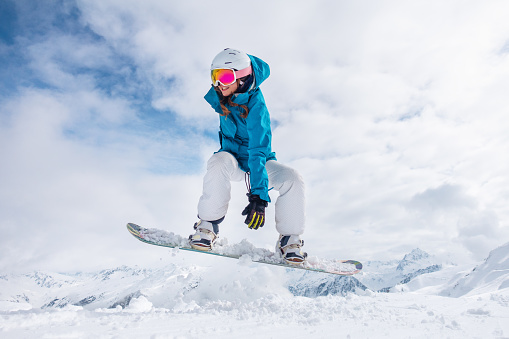 Young woman snowboarding