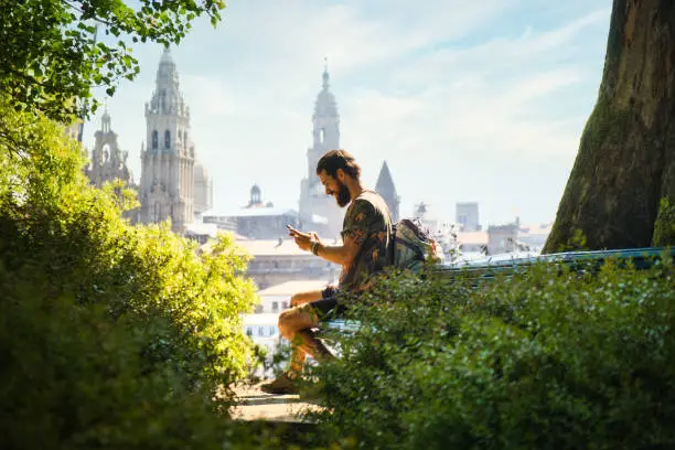 Photo of Young Man On Pilgrimage At Santiago De Compostela With Phone