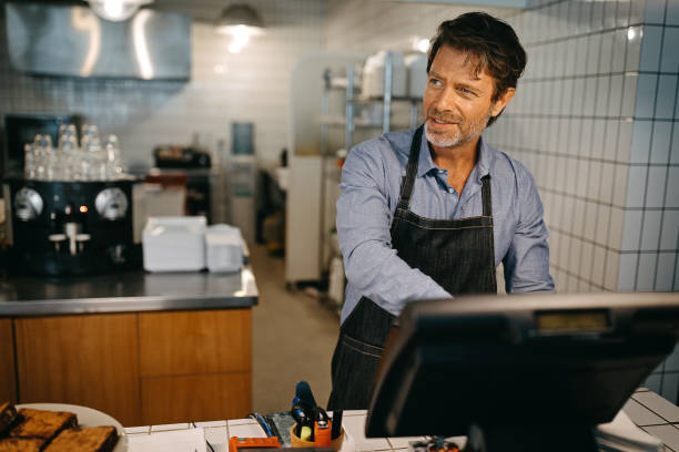 istock Bakery owner working on cash register 1204037875