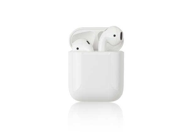 Apple AirPods on a white background. Rostov-on-Don, Russia - December 2019. Apple AirPods on a white background. Wireless headphones in a charging case close-up. in ear headphones stock pictures, royalty-free photos & images