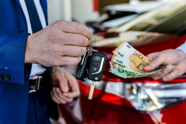 istock Male hands exchanging with euro and car keys 1204041585