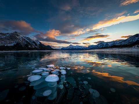 ice bubble and sunrise at Abraham Lake, alberta, canada.