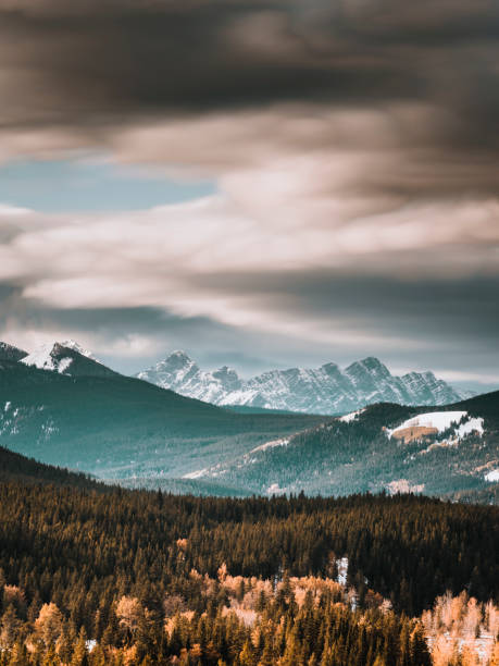 canadian rockies with cloudscape in winter, alberta, canada.